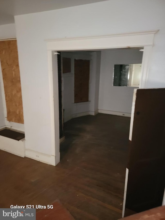 hallway with dark hardwood / wood-style floors