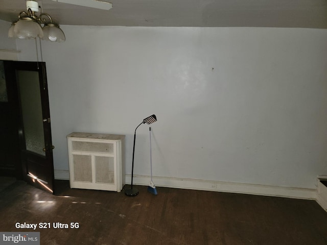 unfurnished room featuring dark wood-type flooring