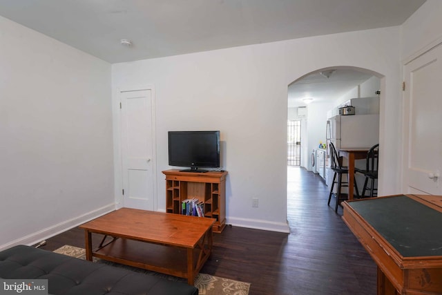 living room featuring dark wood-type flooring