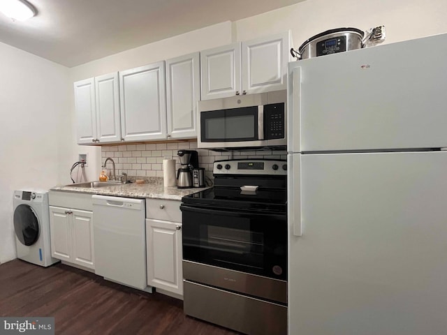 kitchen with sink, backsplash, stainless steel appliances, white cabinets, and washer / clothes dryer