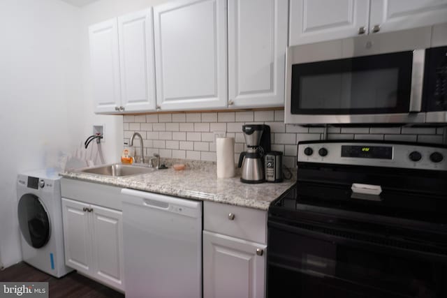 kitchen with sink, dishwasher, range with electric cooktop, white cabinets, and washer / dryer