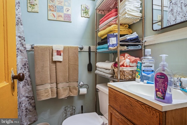 bathroom featuring vanity and toilet