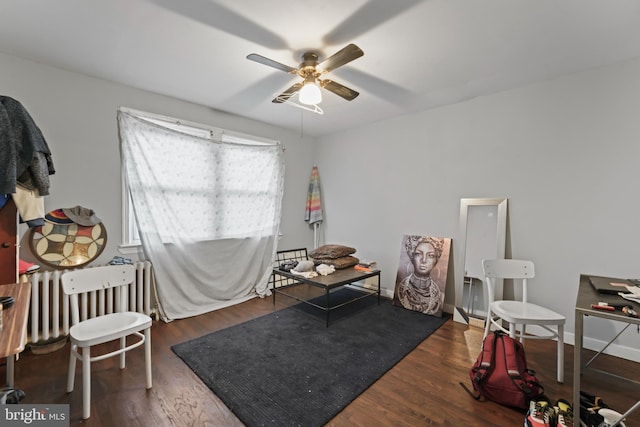 miscellaneous room featuring ceiling fan, dark hardwood / wood-style floors, and radiator