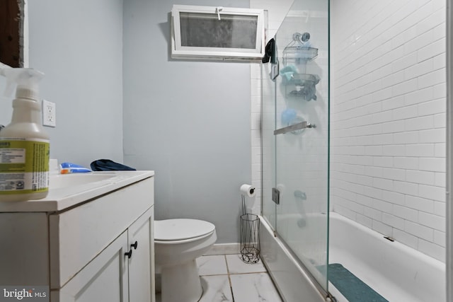 full bathroom with vanity, enclosed tub / shower combo, and toilet