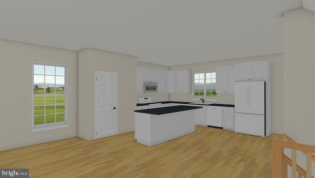 kitchen featuring white appliances, white cabinetry, light wood-style floors, a center island, and dark countertops