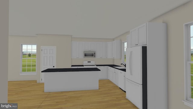 kitchen with dark countertops, white appliances, white cabinetry, and a center island