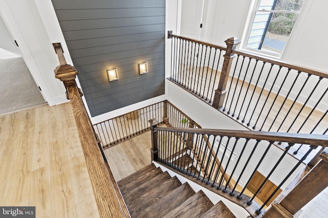 stairs featuring wood finished floors