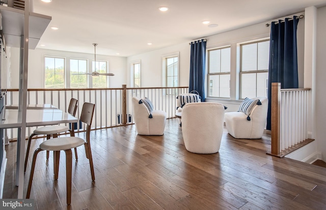 dining space featuring wood-type flooring and ceiling fan