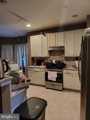 kitchen featuring backsplash, white cabinets, and appliances with stainless steel finishes