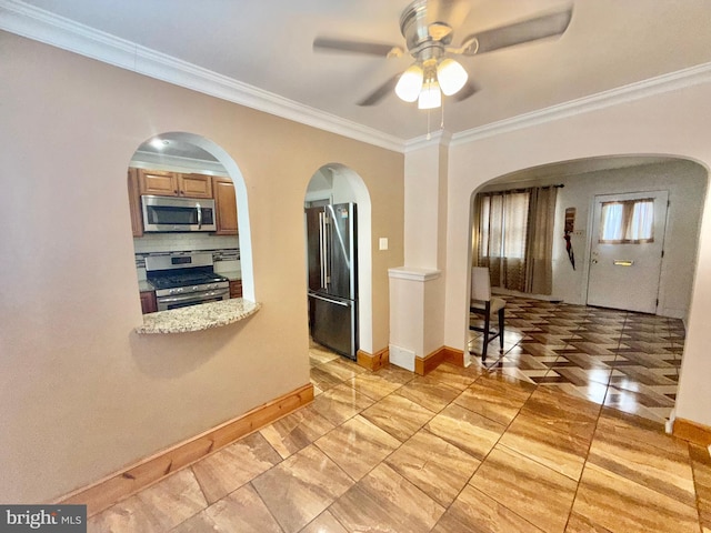 kitchen featuring crown molding, ceiling fan, appliances with stainless steel finishes, and tasteful backsplash