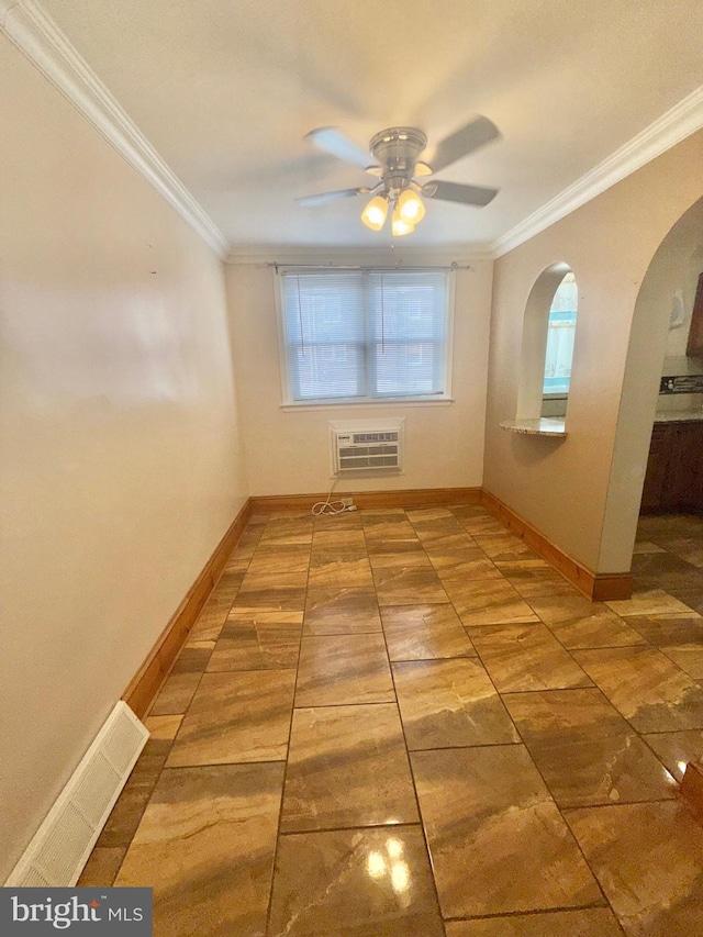 spare room featuring crown molding, ceiling fan, and a wall unit AC