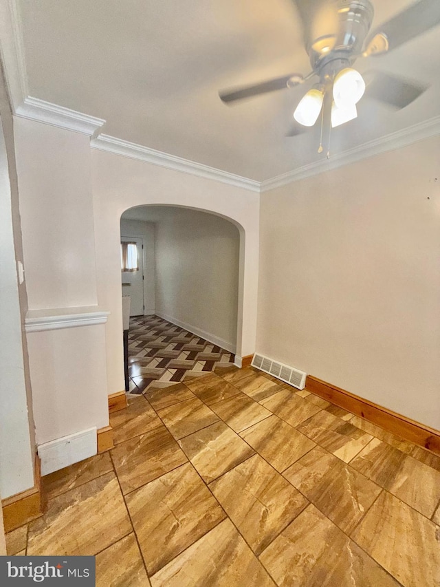 spare room with crown molding and ceiling fan