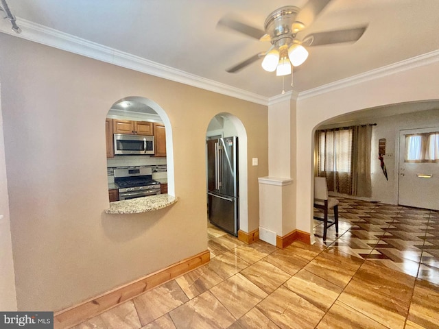 kitchen with decorative backsplash, ornamental molding, ceiling fan, and appliances with stainless steel finishes