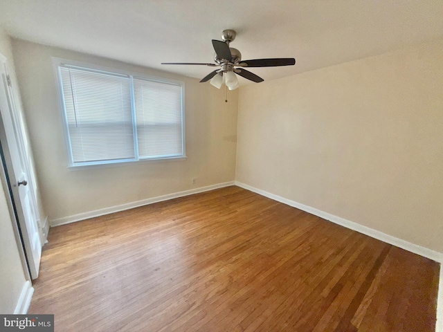 spare room with ceiling fan and light wood-type flooring