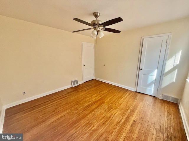 empty room featuring ceiling fan and light wood-type flooring