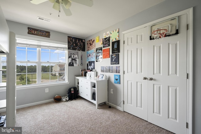 carpeted bedroom featuring baseboards, visible vents, and a ceiling fan