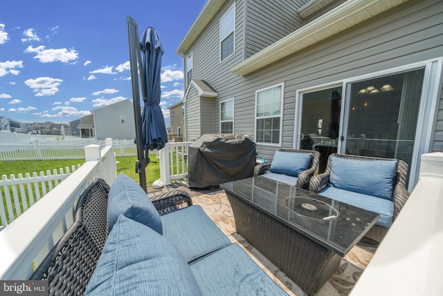 wooden terrace featuring outdoor lounge area, fence, grilling area, and a yard