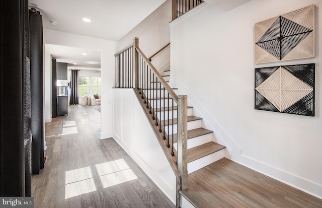 stairs with hardwood / wood-style flooring