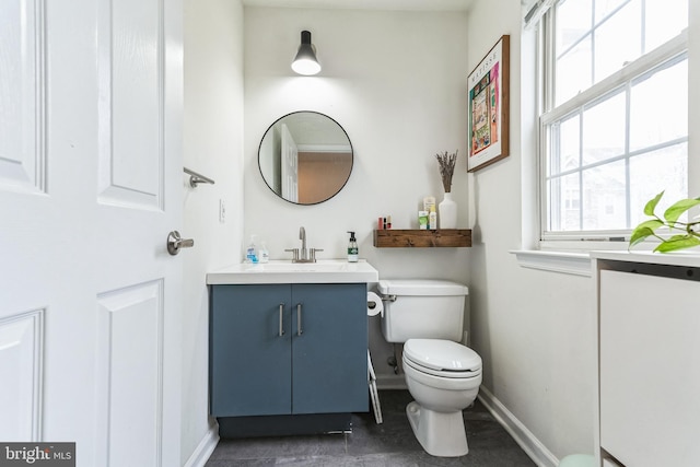 bathroom featuring vanity and toilet