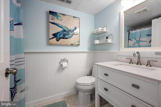 bathroom with tile patterned floors, vanity, and toilet