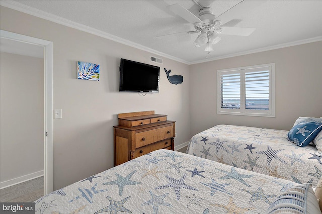 bedroom with ceiling fan, ornamental molding, and a textured ceiling