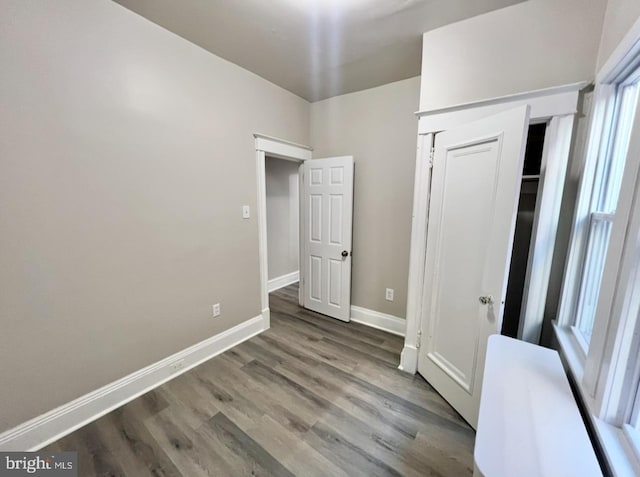 unfurnished bedroom with light hardwood / wood-style floors and a closet