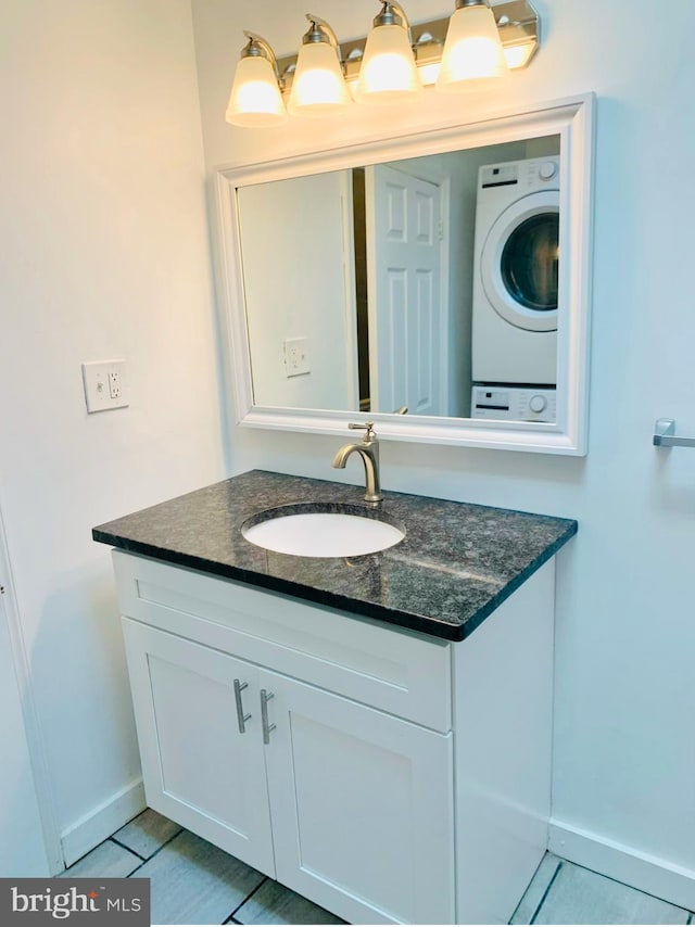 bathroom featuring vanity and stacked washer / drying machine