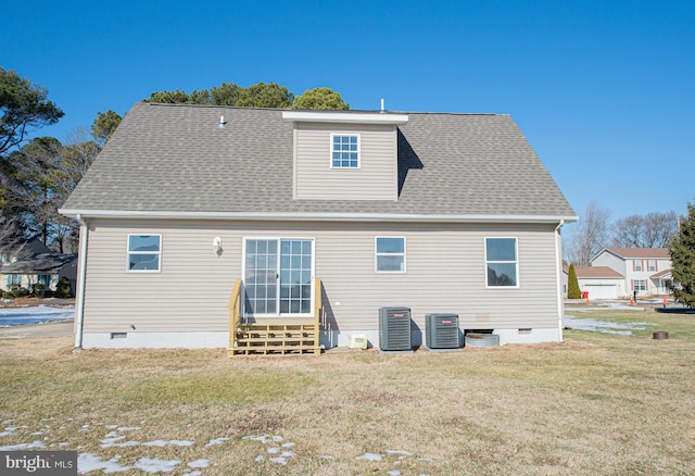 back of property with central AC and a yard