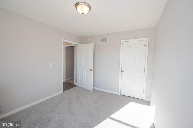 unfurnished bedroom with light carpet