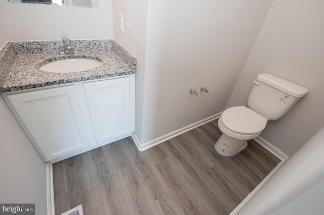 bathroom featuring vanity, toilet, and wood-type flooring