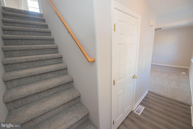 stairway with hardwood / wood-style floors