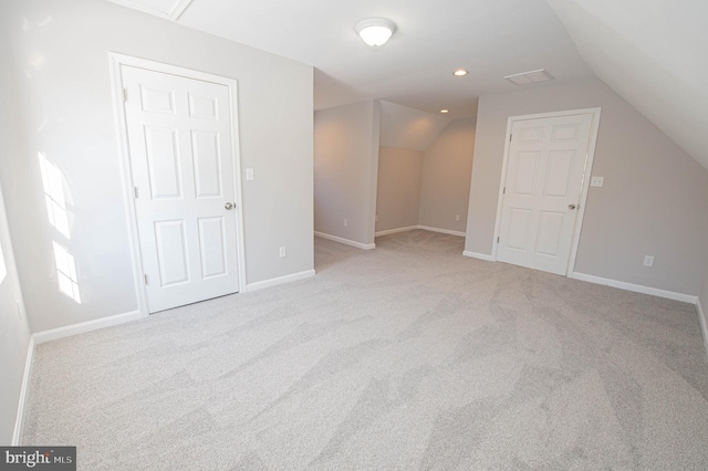 bonus room featuring vaulted ceiling and light colored carpet