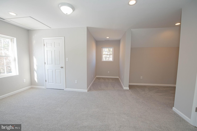 unfurnished room featuring light carpet