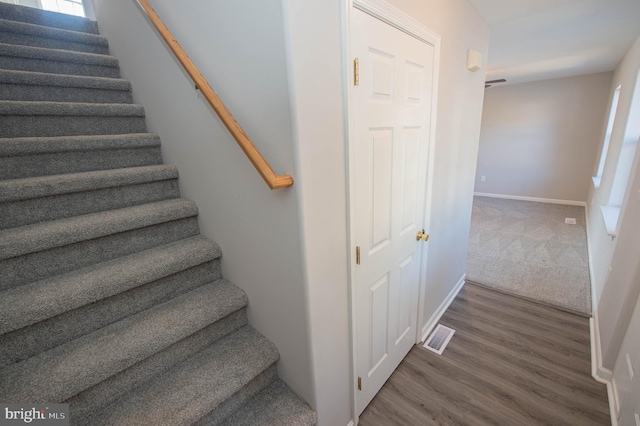 stairs featuring wood-type flooring