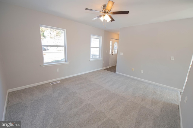 unfurnished room featuring ceiling fan and light carpet