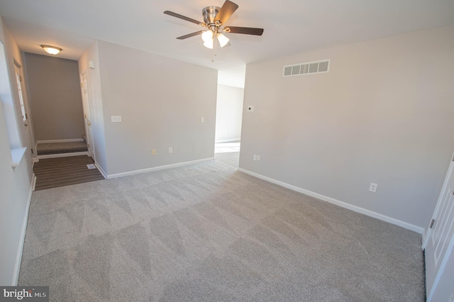 carpeted spare room with ceiling fan