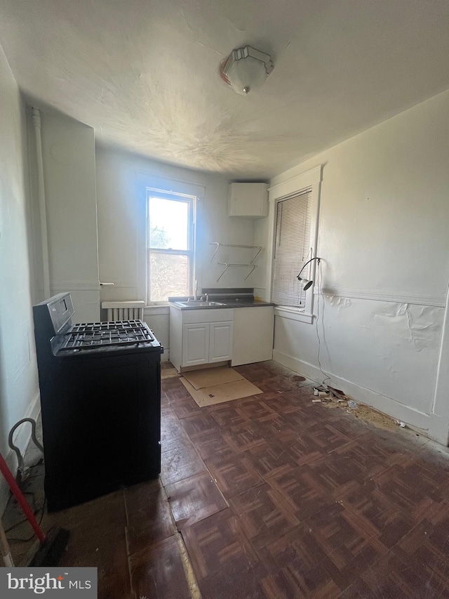 washroom with washer / clothes dryer, sink, and dark parquet floors