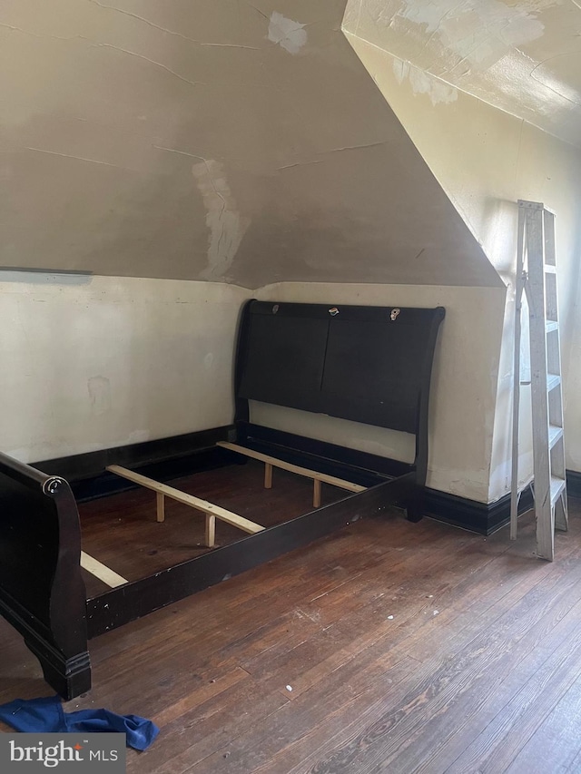 bonus room featuring vaulted ceiling and hardwood / wood-style floors