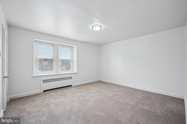 carpeted spare room with radiator