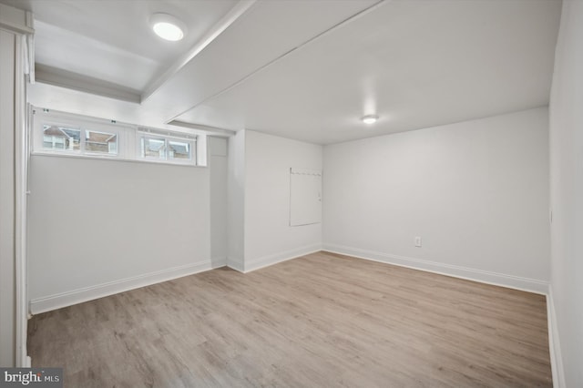 basement with light hardwood / wood-style flooring