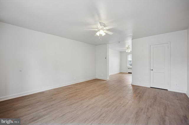 empty room with ceiling fan and light hardwood / wood-style floors