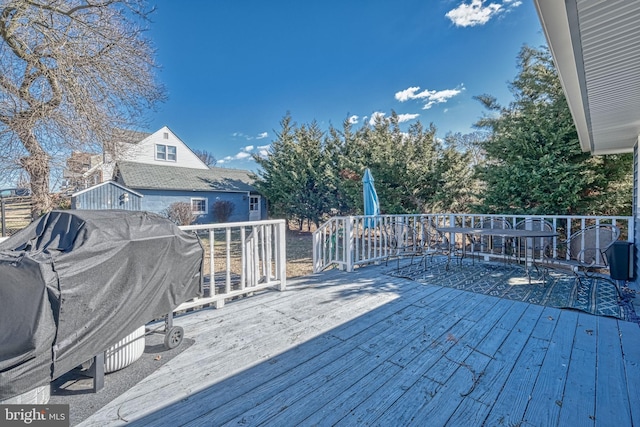 wooden terrace featuring grilling area