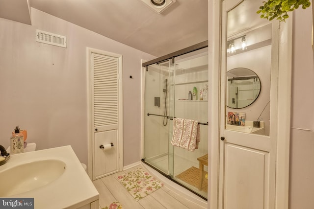 bathroom with vanity and a shower with shower door