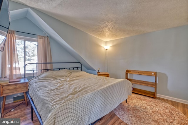 bedroom featuring hardwood / wood-style floors and a textured ceiling