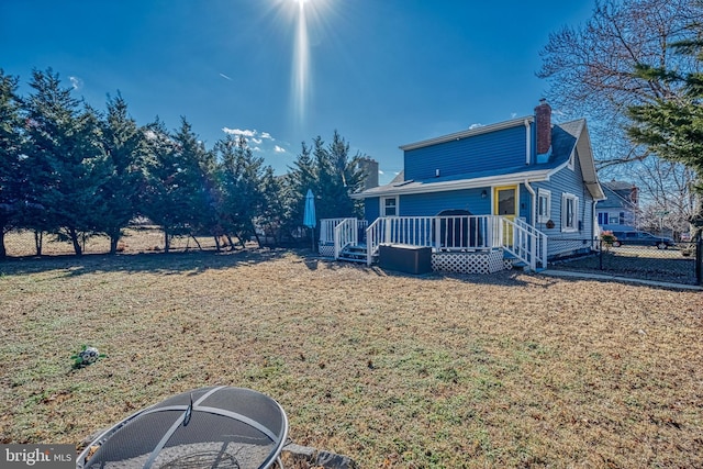 view of side of property featuring a wooden deck and a yard