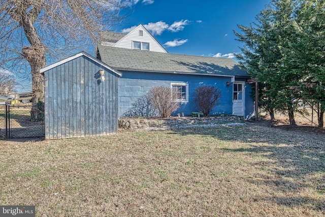 exterior space featuring a storage unit and a front yard