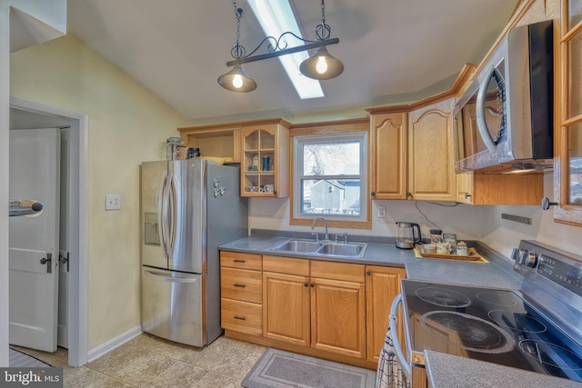 kitchen featuring sink, vaulted ceiling, light tile patterned floors, pendant lighting, and stainless steel appliances