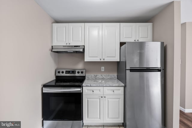 kitchen featuring stainless steel appliances and white cabinets