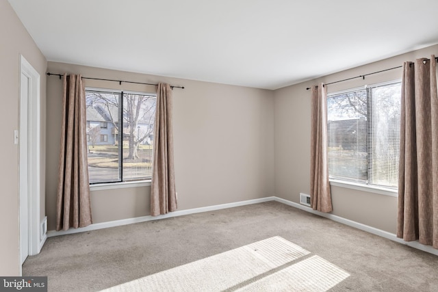 unfurnished room with light carpet