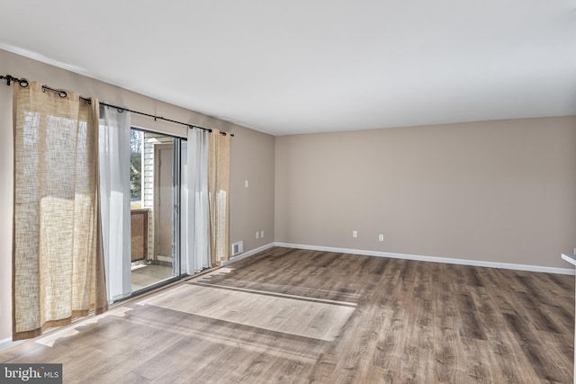 unfurnished room with hardwood / wood-style floors